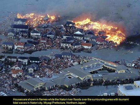 Houses are shown in flames while the Natori river floods over the surrounding area with tsunami tidal waves in Natori city, Miyagi Prefecture, Northern.