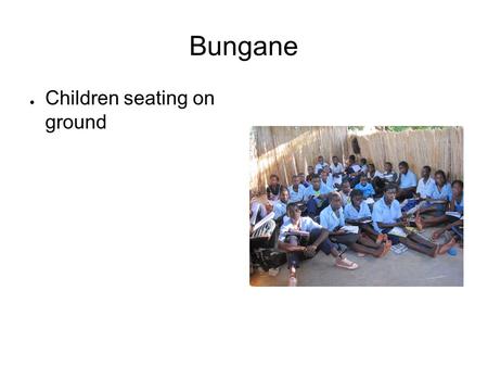 Bungane ● Children seating on ground. The teacher at Bungane ● This teacher teaches the students number one in this presentation.