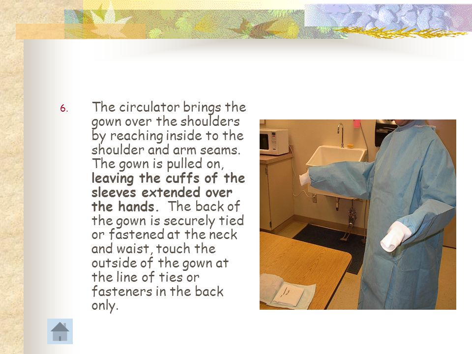 The circulator brings the gown over the shoulders by reaching inside to the shoulder and arm seams.