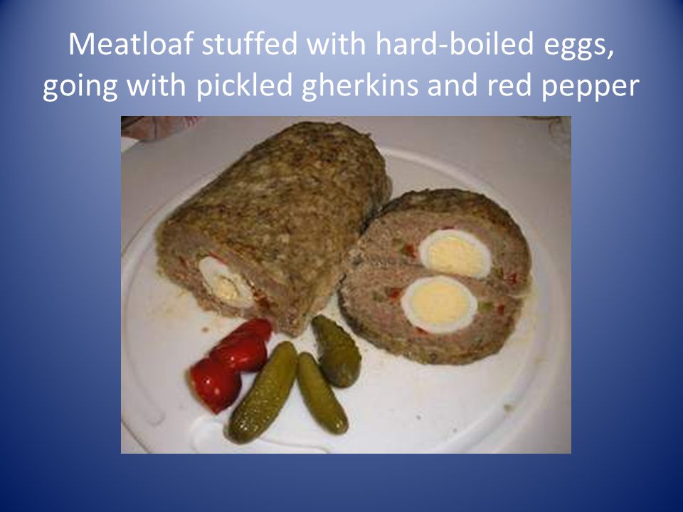 Meatloaf stuffed with hard-boiled eggs, going with pickled gherkins and red pepper
