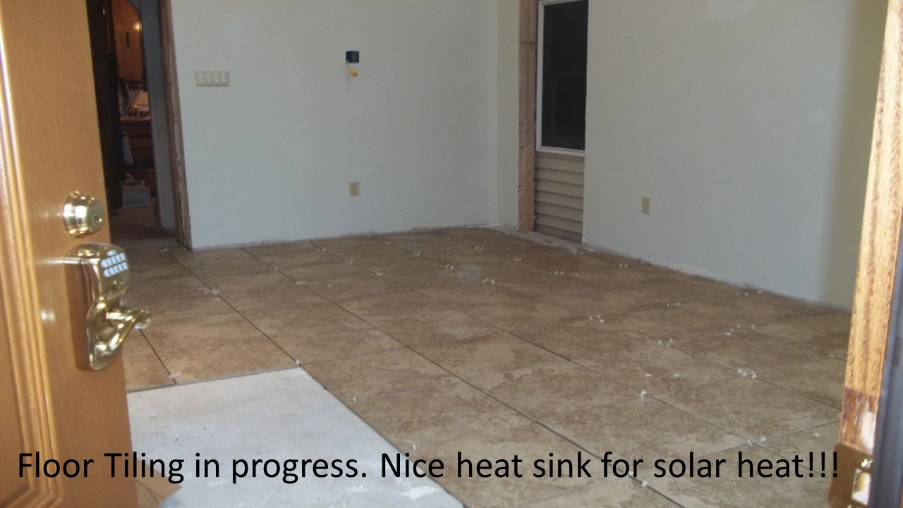 Floor Tiling in progress. Nice heat sink for solar heat!!!