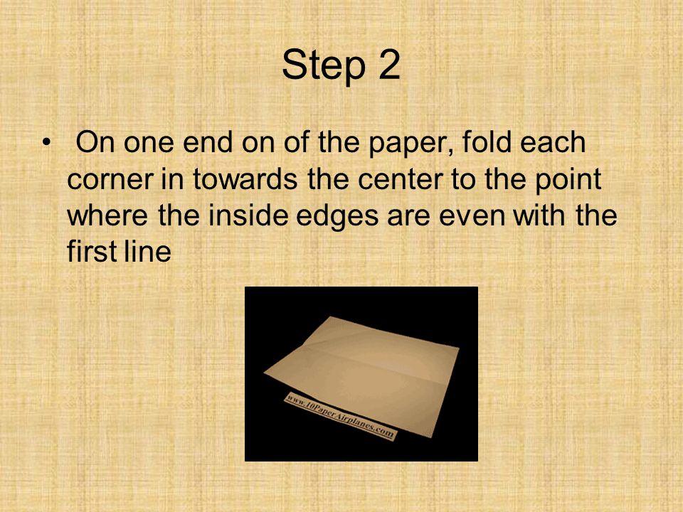 Step 2 On one end on of the paper, fold each corner in towards the center to the point where the inside edges are even with the first line.