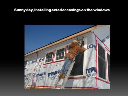 Sunny day, installing exterior casings on the windows.