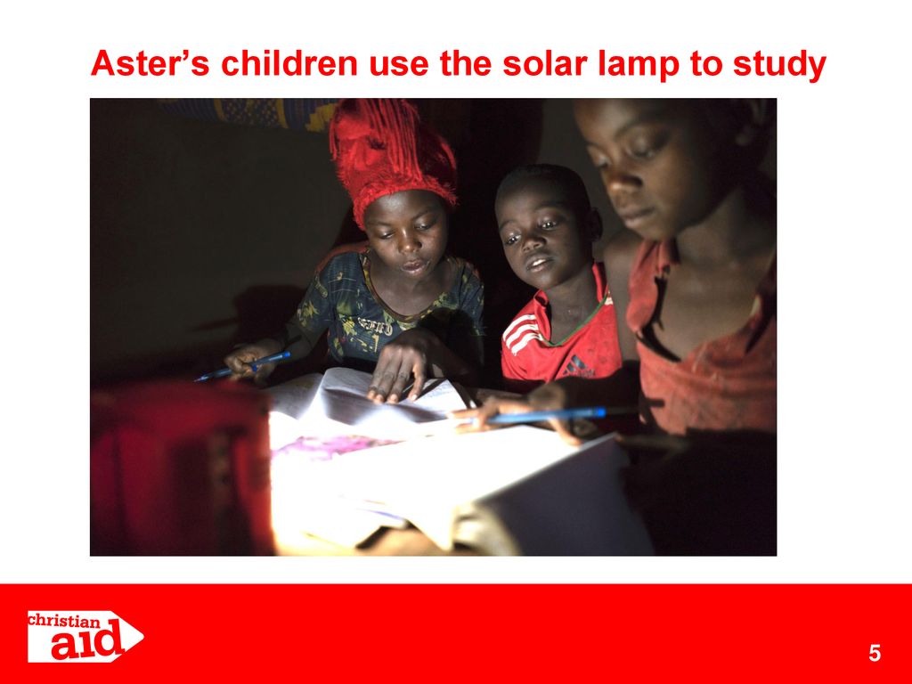 Aster’s children use the solar lamp to study