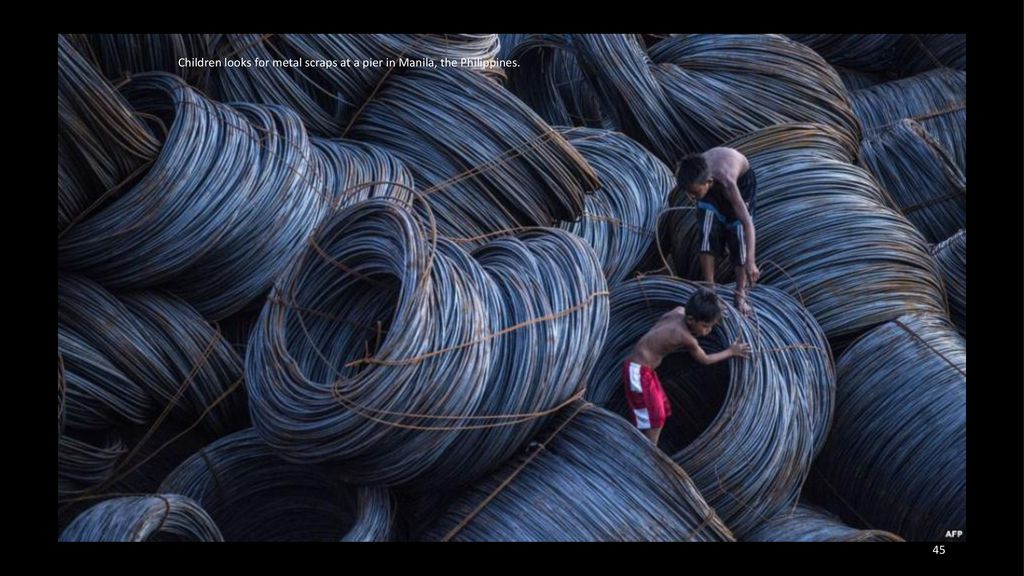 Children looks for metal scraps at a pier in Manila, the Philippines.