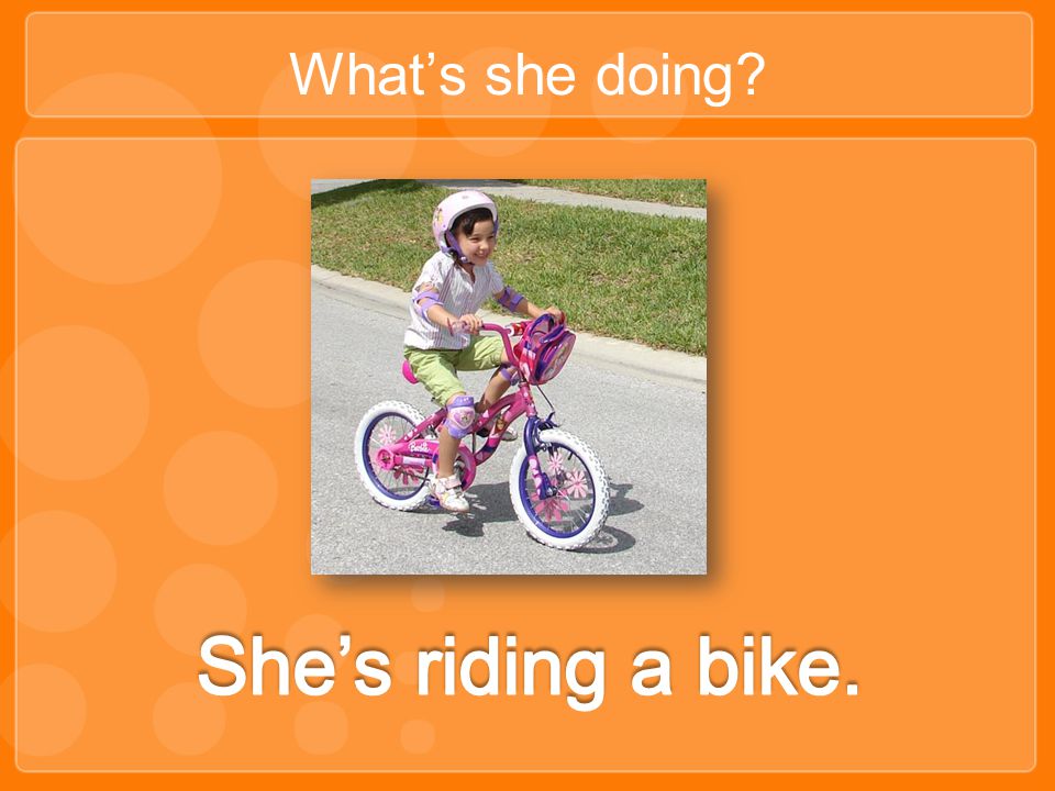What’s she doing She’s riding a bike.