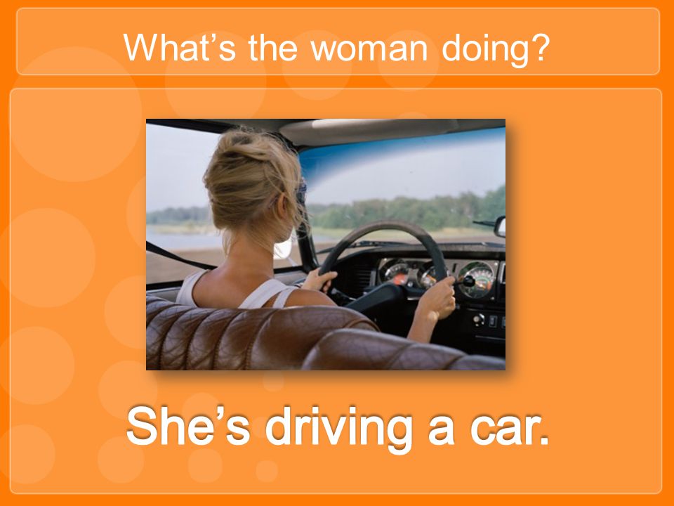 What’s the woman doing She’s driving a car.