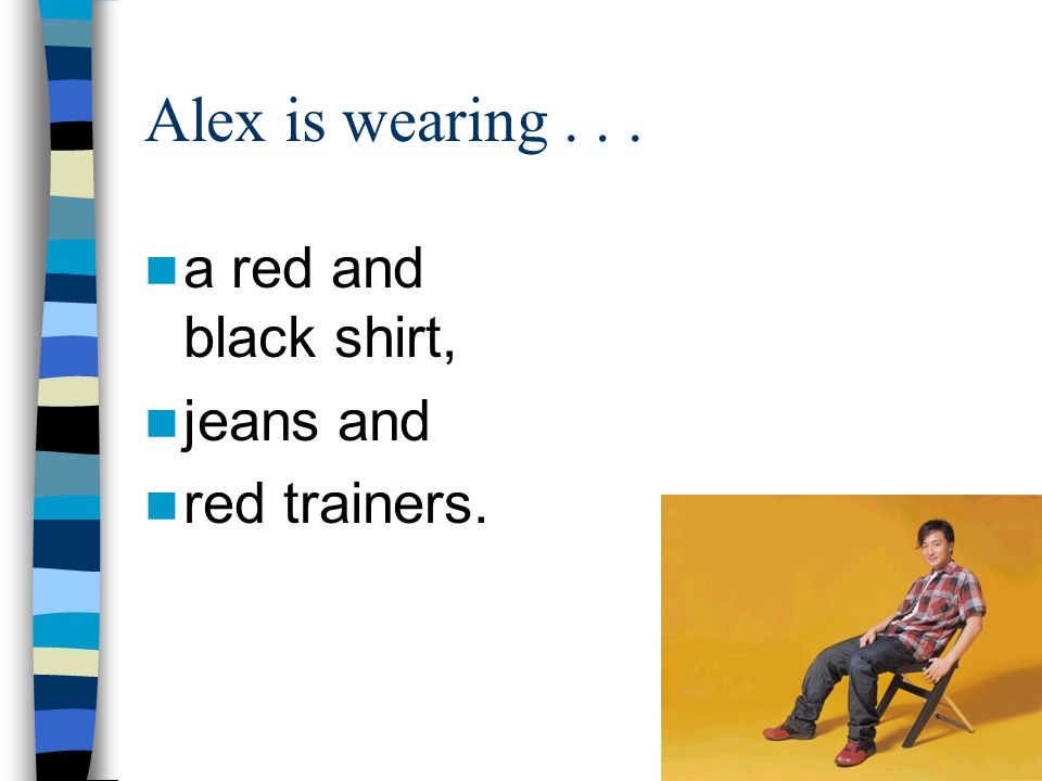 Alex is wearing a red and black shirt, jeans and red trainers.