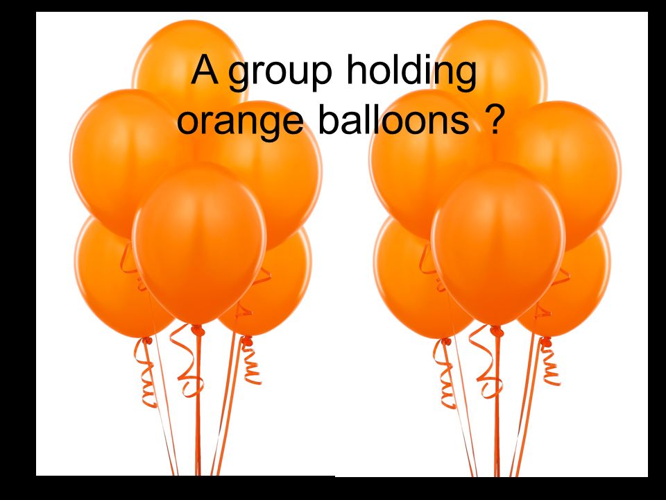 A group holding orange balloons