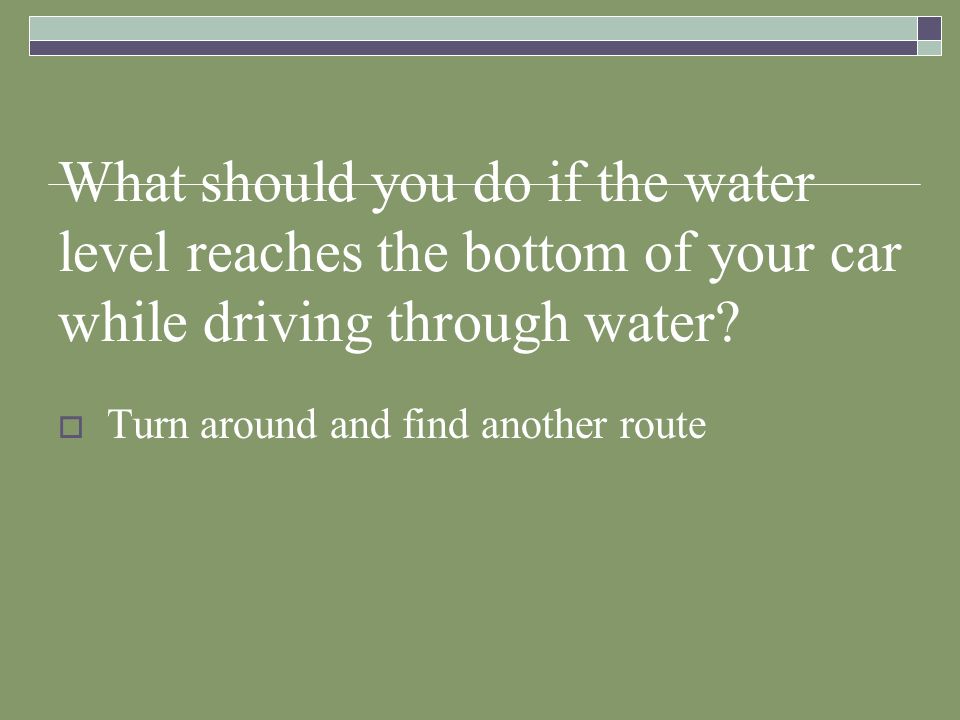 What should you do if the water level reaches the bottom of your car while driving through water