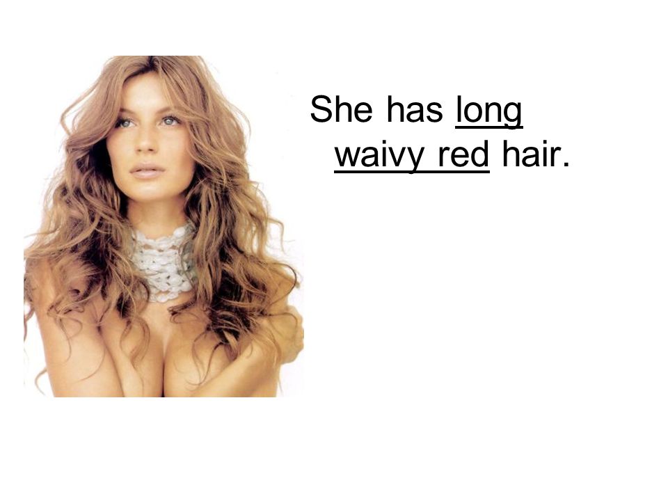 She has long waivy red hair.