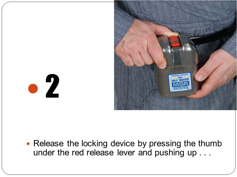 2 Release the locking device by pressing the thumb under the red release lever and pushing up