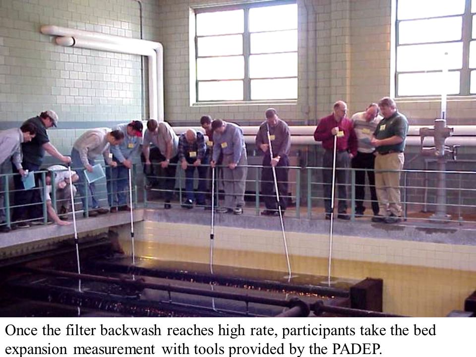 Once the filter backwash reaches high rate, participants take the bed expansion measurement with tools provided by the PADEP.
