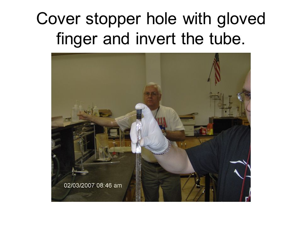 Cover stopper hole with gloved finger and invert the tube.